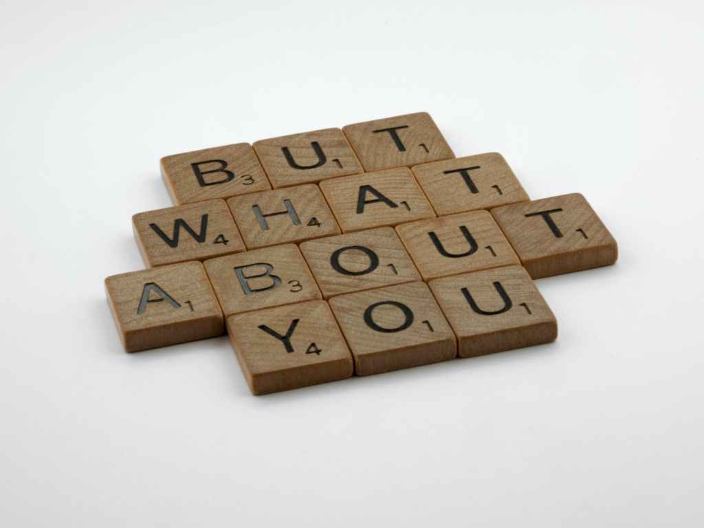 wooden scrabble tile with a message